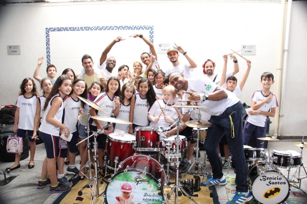 Group of happy kids playing drums together during a music lesson