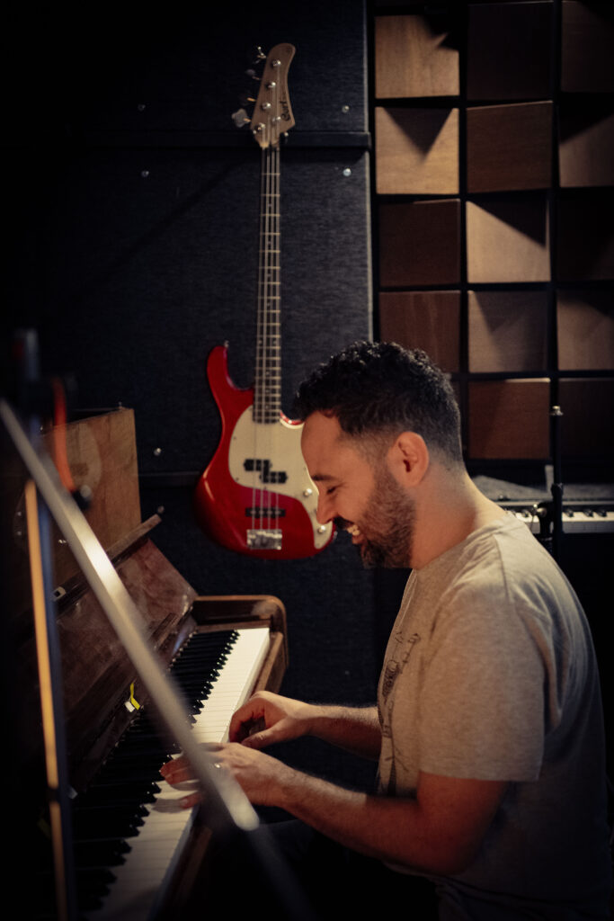 Gustavo Soares, music teacher at GS Music Lessons, playing drums passionately in a professional studio setting.

