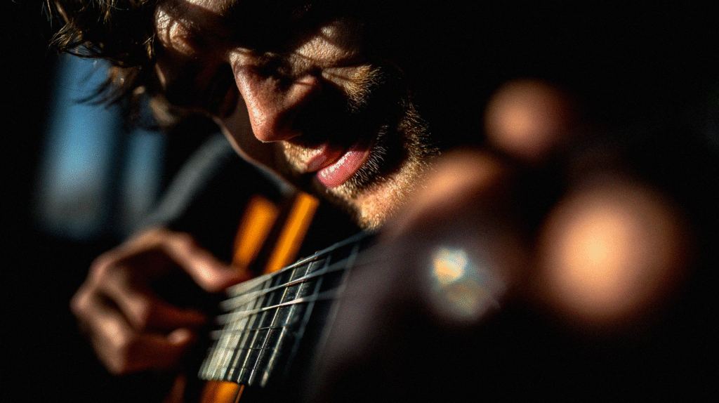 Close-up of a guitarist’s face focused in deep concentration while playing, symbolizing practice and growth.